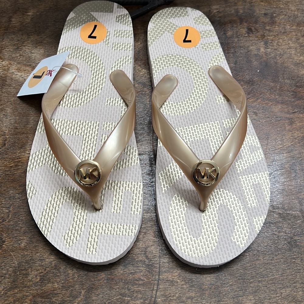 Micheal Kors Gold and cream flip flops size 7